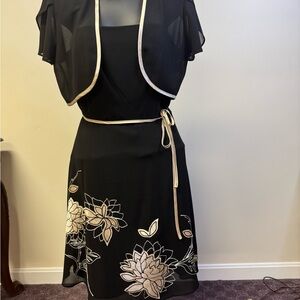 Beautiful black dress with satin flowers on the front with the belt to match